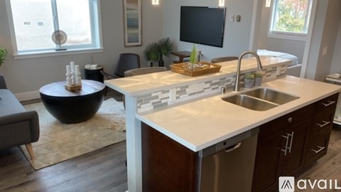 A modern kitchen with a stainless steel dishwasher and a wooden countertop.