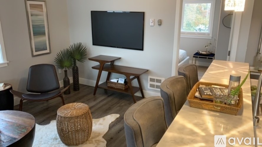 A living room with a flat screen TV mounted on the wall.