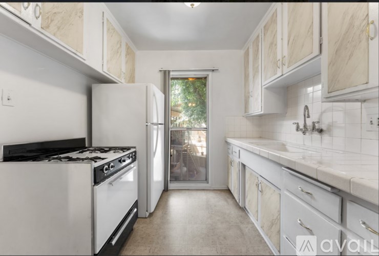 A kitchen with a white stove top oven and a white refrigerator.