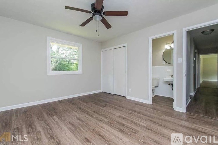 A room with a ceiling fan and a window.