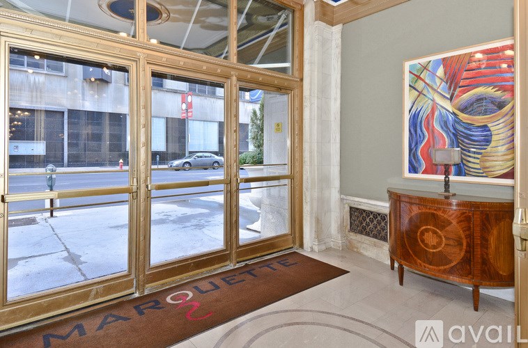 A room with a wooden cabinet and a painting on the wall.
