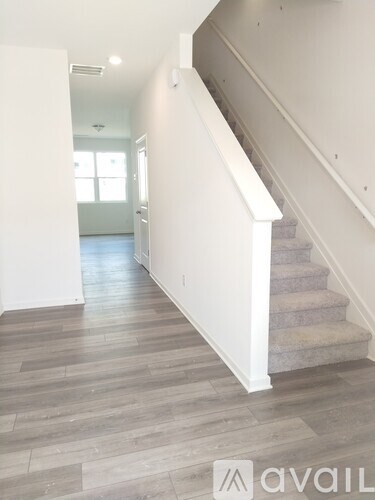 A staircase with a white railing and wooden steps.