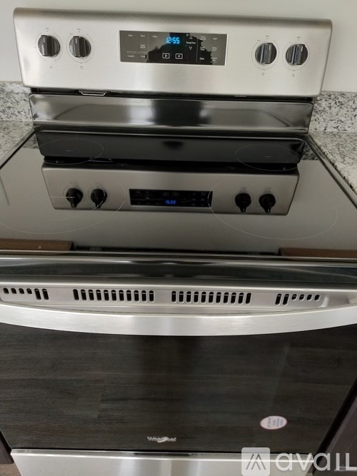 A stainless steel oven with a digital display and control panel.