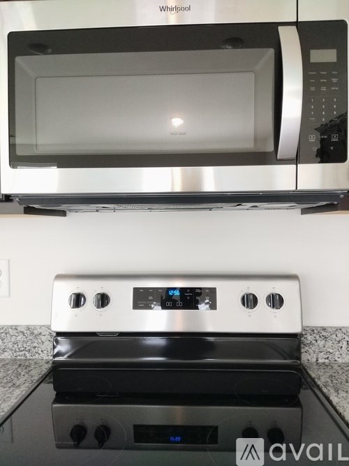 A Whirlpool microwave and oven are on a kitchen counter.