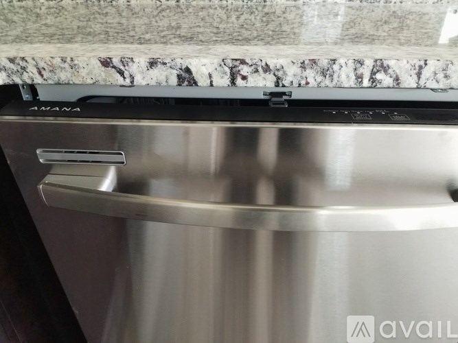 A close up of a stainless steel oven with the word "AVAILABLE" on the bottom right corner.