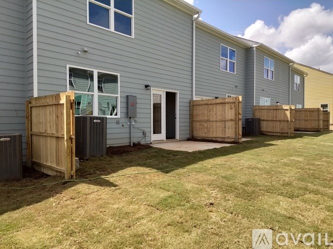A row of houses with a sign that says "AVAILABLE" in front of them.
