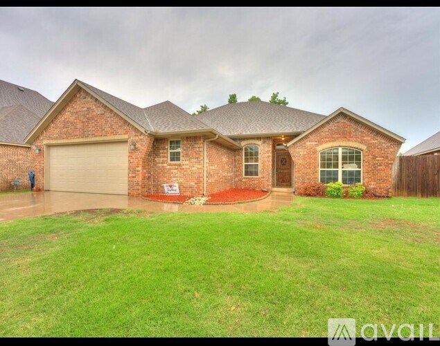 A house with a brick exterior and a garage is available for sale.
