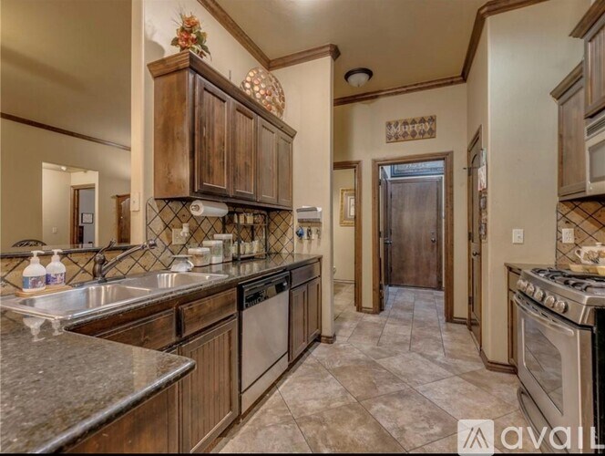 A kitchen with wooden cabinets and a tile floor.
