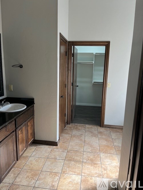 A bathroom with a sink and a door.
