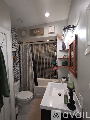 A bathroom with a toilet, sink, and shower.
