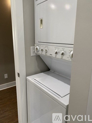 A white oven with a door open is installed in a kitchen.