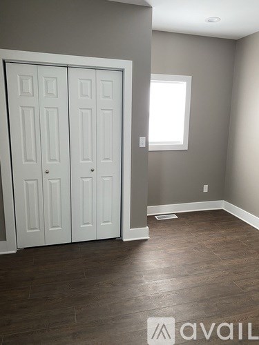 A room with a white door and a window.