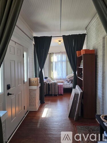 A room with a bed and a dresser with a mirror.