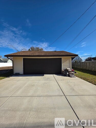 A two-car garage with a brown roof and a white wall.