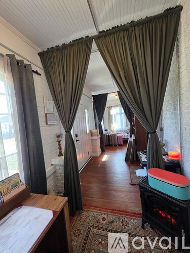 A room with a fireplace and a rug on the floor.