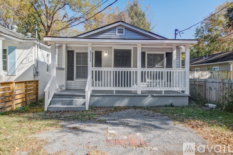 A small house with a porch is for sale.