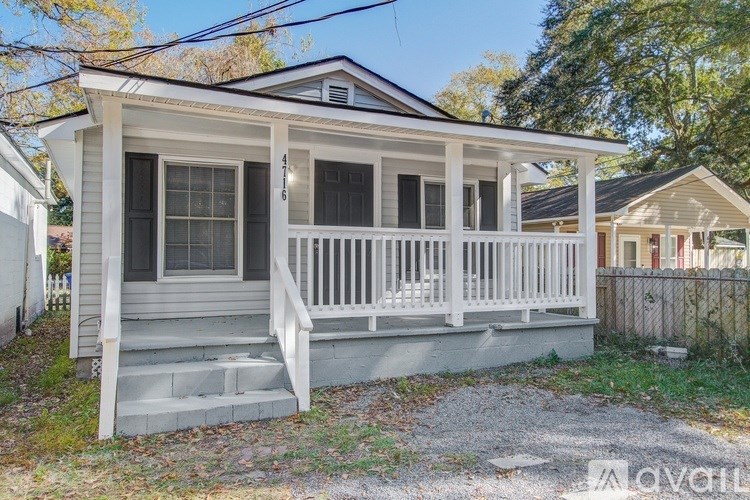 A small house with a porch and a covered entrance.