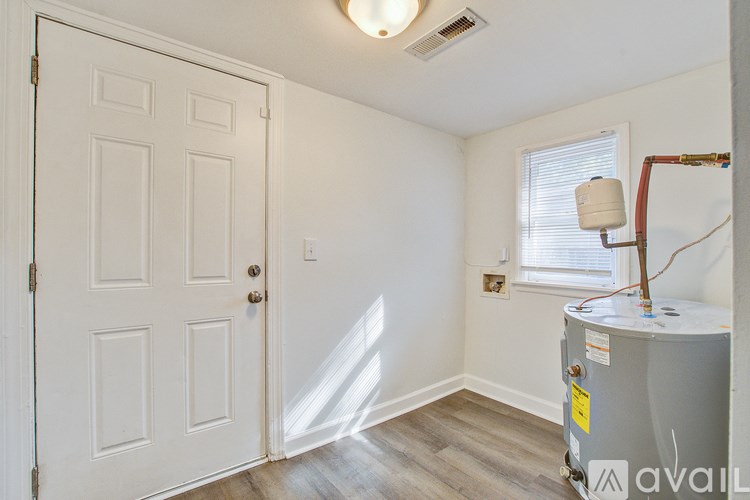 A room with a door, a window, and a tank.