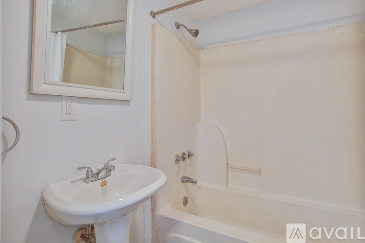 A white sink with a mirror above it in a bathroom.