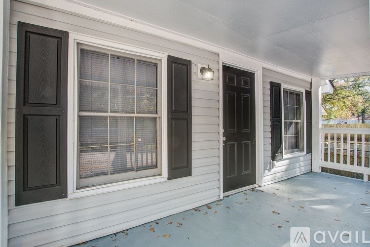 A white house with a black door and window.