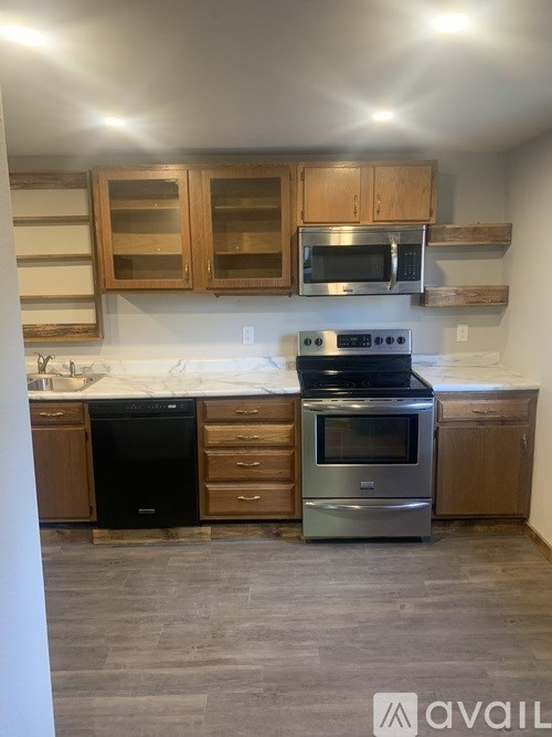 A kitchen with a stove top oven and microwave above it.