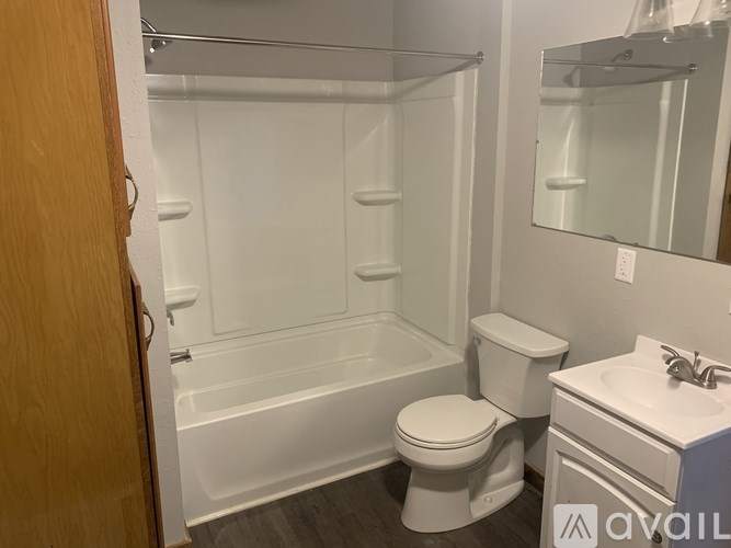 A bathroom with a toilet, sink, and bathtub.
