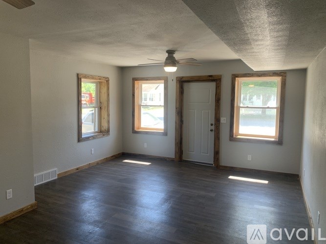 A room with a wooden floor and a ceiling fan.