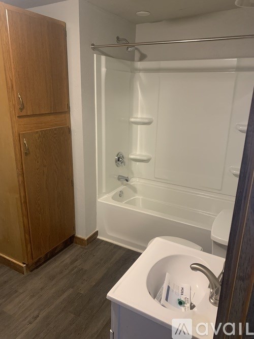 A bathroom with a white sink and a white bathtub.