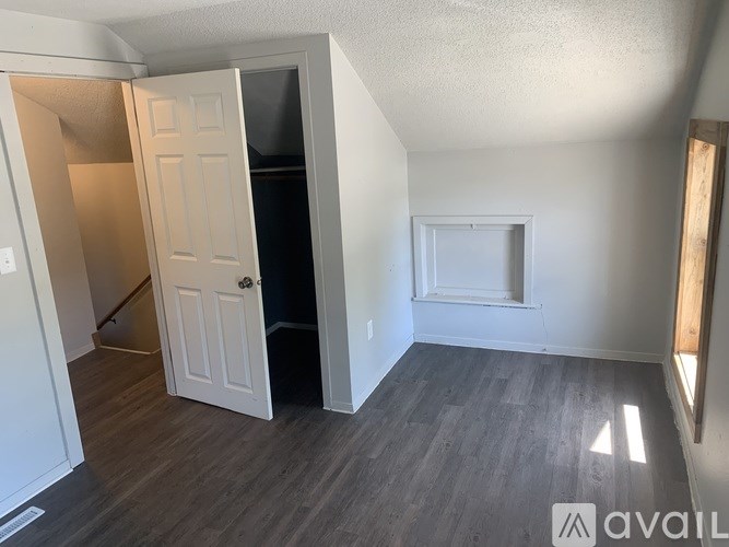 A room with a white door and a window with a white frame.