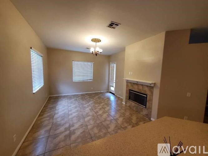 A living room with a fireplace and a chandelier.