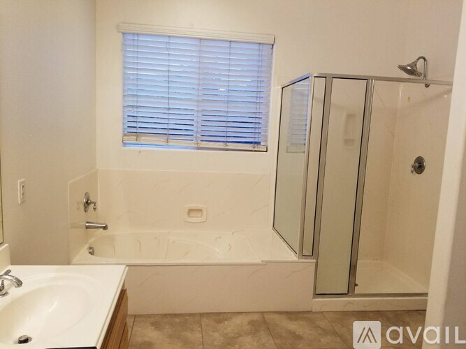 A bathroom with a bathtub, sink, and shower.