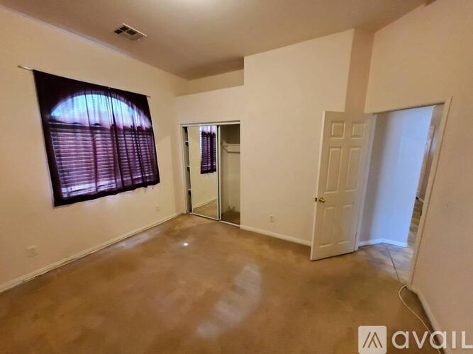 A room with a sliding glass door and a white door.