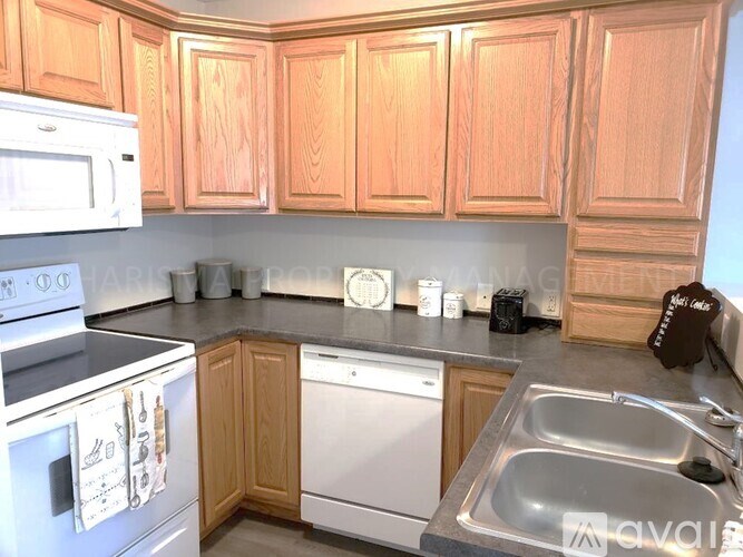 A kitchen with wooden cabinets and stainless steel appliances.