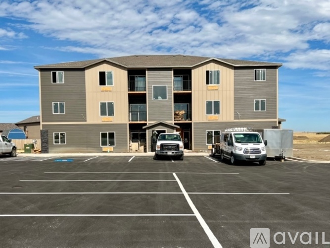A large building with a parking lot in front of it.