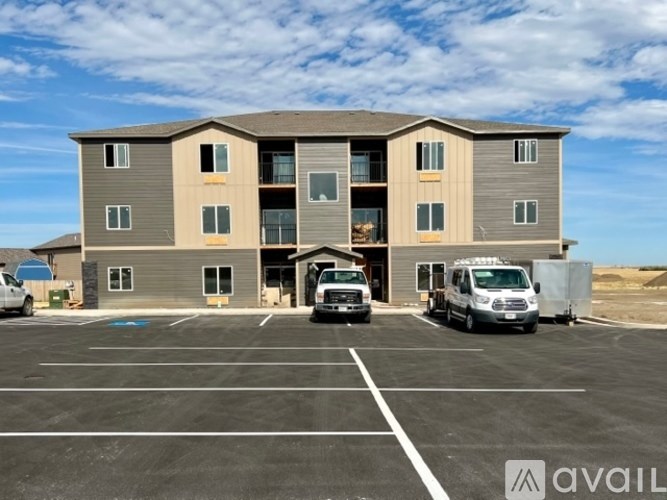 A large building with a parking lot in front of it.