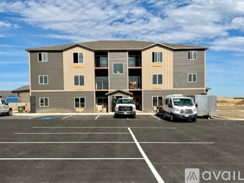 A large building with a parking lot in front of it.
