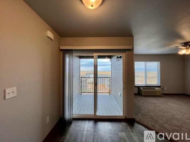 A room with a sliding door leading to a balcony.