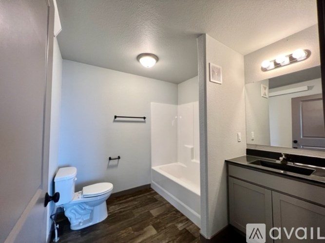 A bathroom with a toilet, sink, and bathtub.