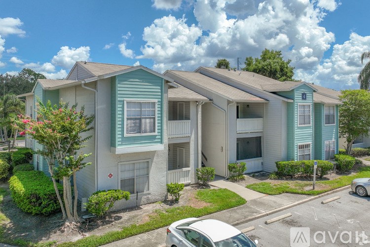 A row of townhouses with a car parked in front.