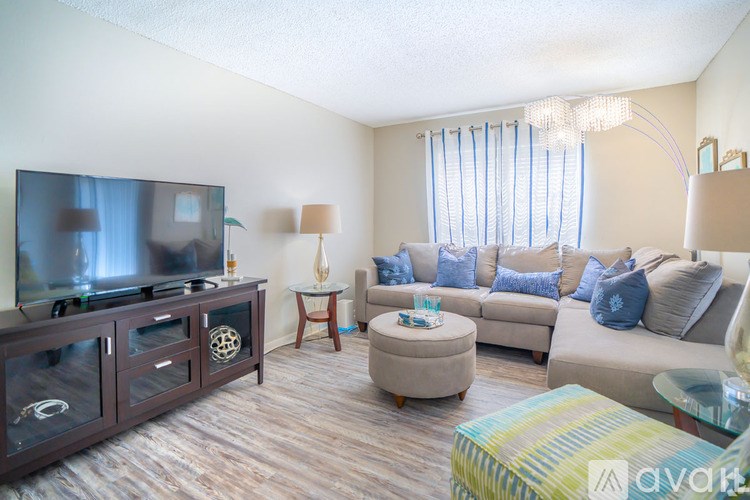 A living room with a television, couch, and a coffee table.