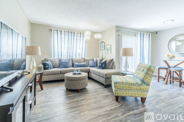 A living room with a sofa, chair, and coffee table.