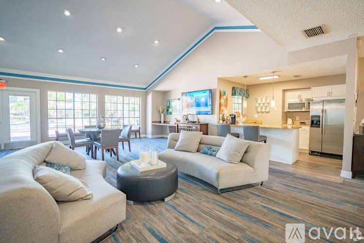 A living room with a couch, a coffee table, and a television.