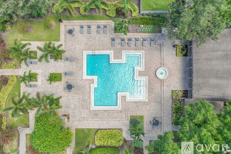 An aerial view of a pool surrounded by a garden.