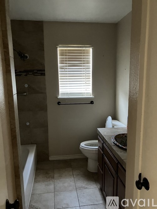 A bathroom with a toilet, sink, and bathtub.