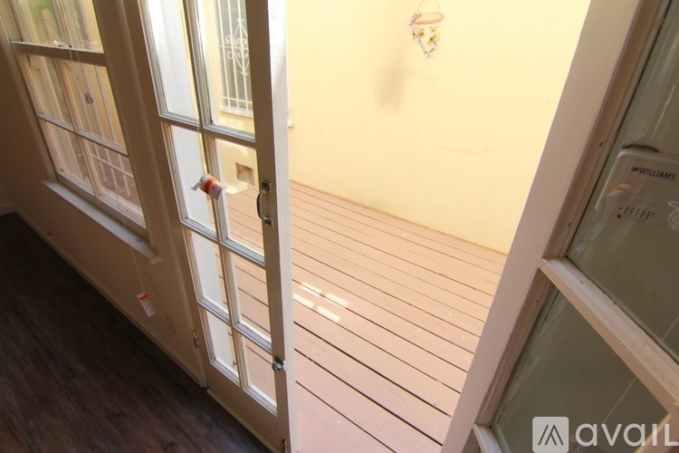 A white door with a glass window is open.