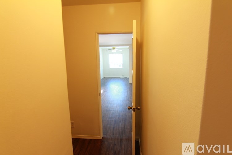 A hallway with a door at the end.