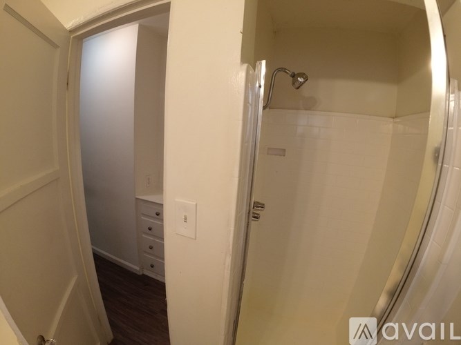 A bathroom with a shower and a toilet.