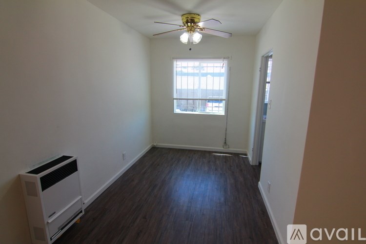A room with a window and a fan.