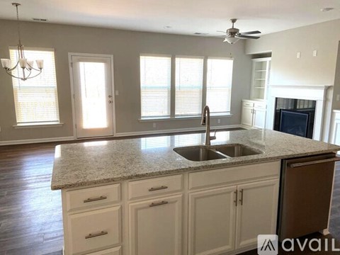 A kitchen with a sink and a fan.
