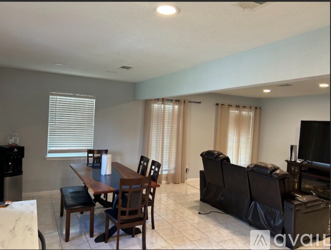 A living room with a dining table and chairs.